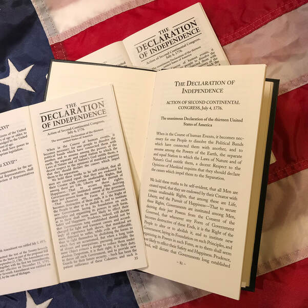 Images of the Declaration of Independence against a red, white, and blue background.  Photo by Lynne Schall