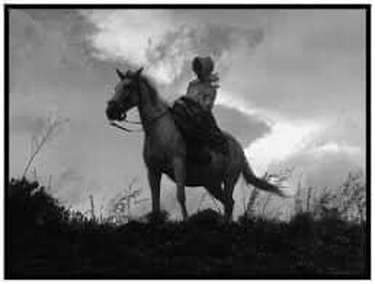Woman rancher on horseback.  Black & white photo