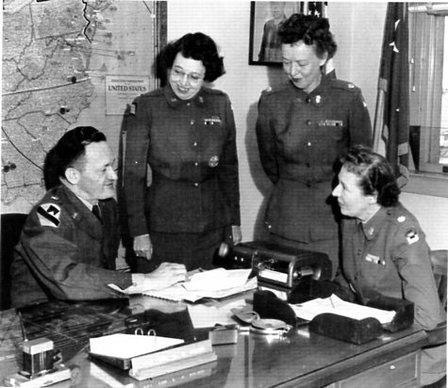 Major General Palmer confers with three WAC officers regarding the move of the WAC Center & School to Alabama