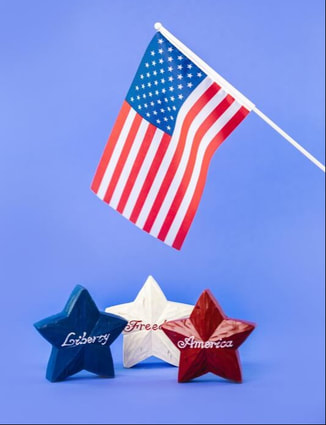 Color image of USA flag with three stars in the foreground.  One of the three stars is labeled liberty, a second is freedom, and the third is America.  